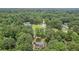 Aerial view of home on lot surrounded by trees at 1904 Britt Dr, Snellville, GA 30078