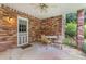 Cozy back porch with brick walls and a ceiling fan at 1904 Britt Dr, Snellville, GA 30078