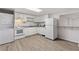 Basement kitchen featuring white cabinets, modern appliances, and laundry machines at 1904 Britt Dr, Snellville, GA 30078