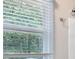 Bathroom window with blinds overlooking the wooded backyard at 1904 Britt Dr, Snellville, GA 30078