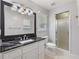 Clean bathroom with a marble countertop vanity, frosted glass shower, and tile flooring at 1904 Britt Dr, Snellville, GA 30078