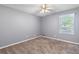 Bedroom featuring neutral carpet, a ceiling fan, and a window with natural light at 1904 Britt Dr, Snellville, GA 30078