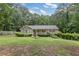Inviting single-story house with a well-maintained lawn surrounded by trees at 1904 Britt Dr, Snellville, GA 30078