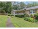 Charming single-story house with a cozy front porch and beautifully landscaped yard at 1904 Britt Dr, Snellville, GA 30078