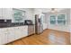 Well-lit kitchen with white cabinets, stainless steel appliances, and hardwood flooring at 1904 Britt Dr, Snellville, GA 30078