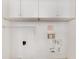 Empty laundry room with white walls and upper cabinets with space for a washer and dryer at 1904 Britt Dr, Snellville, GA 30078