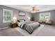 Staged main bedroom with bed, chairs, and carpet at 1904 Britt Dr, Snellville, GA 30078