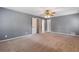 Spacious main bedroom with carpet, a ceiling fan, and multiple doorways at 1904 Britt Dr, Snellville, GA 30078