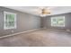 Spacious main bedroom with carpet, a ceiling fan, and large windows at 1904 Britt Dr, Snellville, GA 30078