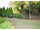 Well-maintained backyard features manicured landscaping, a privacy fence and a grassy lawn area at 1951 Barrett Knoll Nw Cir, Kennesaw, GA 30152