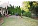 Charming backyard featuring a brick patio, well-manicured lawn, and privacy trees at 1951 Barrett Knoll Nw Cir, Kennesaw, GA 30152