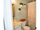 Cozy bathroom featuring decorative shelves, neutral tones, and a floral shower curtain at 1951 Barrett Knoll Nw Cir, Kennesaw, GA 30152