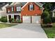 Charming two-story brick home with a well-manicured lawn and a two-car garage at 1951 Barrett Knoll Nw Cir, Kennesaw, GA 30152