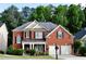 Charming brick home with well-manicured landscaping, covered porch, and two-car garage at 1951 Barrett Knoll Nw Cir, Kennesaw, GA 30152