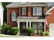 Charming brick home with a covered front porch, neat landscaping, and inviting curb appeal at 1951 Barrett Knoll Nw Cir, Kennesaw, GA 30152