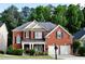 Charming two-story brick home with well-maintained landscaping, inviting porch, and a two-car garage at 1951 Barrett Knoll Nw Cir, Kennesaw, GA 30152