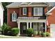 Charming brick home with a covered front porch, manicured landscaping, and decorative shutters at 1951 Barrett Knoll Nw Cir, Kennesaw, GA 30152