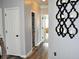 Hallway featuring wood-look floors, light gray walls, and doors leading to various rooms at 1951 Barrett Knoll Nw Cir, Kennesaw, GA 30152