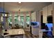 Bright kitchen with large windows, white cabinets, modern appliances, an island with seating, and a dining table at 1951 Barrett Knoll Nw Cir, Kennesaw, GA 30152