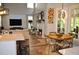 Open-concept living area featuring a fireplace, large windows, and modern decor, adjacent to a dining space at 1951 Barrett Knoll Nw Cir, Kennesaw, GA 30152