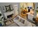 Living room featuring a fireplace, sofa, views of kitchen, dining, and multiple leafy plants at 1951 Barrett Knoll Nw Cir, Kennesaw, GA 30152