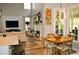 Open-concept living area featuring a fireplace, large windows, and modern decor, adjacent to a dining space at 1951 Barrett Knoll Nw Cir, Kennesaw, GA 30152