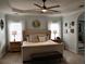 Relaxing main bedroom with a tray ceiling, fan, neutral walls, and coordinated furnishings at 1951 Barrett Knoll Nw Cir, Kennesaw, GA 30152