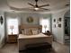 Spacious main bedroom featuring a tray ceiling, carpet, bench, and modern ceiling fan at 1951 Barrett Knoll Nw Cir, Kennesaw, GA 30152