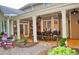 Spacious covered patio features stone flooring, dining table, ceiling fans and easy access to the backyard at 1951 Barrett Knoll Nw Cir, Kennesaw, GA 30152