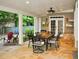 Spacious covered patio featuring stone flooring, a dining table with seating, and a garden area at 1951 Barrett Knoll Nw Cir, Kennesaw, GA 30152