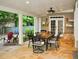 Relaxing covered patio with stone flooring, dining area, and a view of the landscaped backyard at 1951 Barrett Knoll Nw Cir, Kennesaw, GA 30152