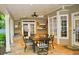 Back patio features a dining table set, stone floor, ceiling fan, and a grill area at 1951 Barrett Knoll Nw Cir, Kennesaw, GA 30152