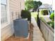 Side yard featuring an air conditioning unit, sidewalk, and wood retaining wall at 1951 Barrett Knoll Nw Cir, Kennesaw, GA 30152