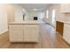 Bright kitchen featuring white cabinets and granite countertops that opens to a living room with a fireplace at 324 Bloomfield Cir, Canton, GA 30114