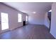 An open-concept living room features a fireplace, wood-grain vinyl floors, and lots of light from the door and windows at 324 Bloomfield Cir, Canton, GA 30114
