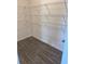 A walk-in pantry features wood-grain vinyl flooring and white wire shelving at 324 Bloomfield Cir, Canton, GA 30114