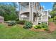 Backyard with landscaped garden beds, a swimming pool and a patio with a staircase leading to an upper deck at 6440 Westchester Pl, Cumming, GA 30040