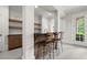 Basement bar with counter seating and adjacent floating shelves at 6440 Westchester Pl, Cumming, GA 30040