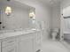 Bright bathroom features marble countertops, white cabinetry, and a glass-enclosed shower at 6440 Westchester Pl, Cumming, GA 30040