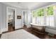 Bright bathroom featuring a freestanding tub, hardwood floors, and large windows at 6440 Westchester Pl, Cumming, GA 30040