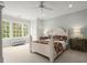 Cozy bedroom with large windows offering natural light and a decorative ceiling fan at 6440 Westchester Pl, Cumming, GA 30040