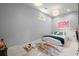 Minimalist bedroom with unique window, bed on floor, and plenty of natural light at 6440 Westchester Pl, Cumming, GA 30040