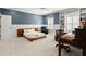 Spacious bedroom with built-in bookshelves, a desk, and ample natural light at 6440 Westchester Pl, Cumming, GA 30040