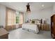 Comfortable bedroom with neutral tones, a large window, and natural light at 6440 Westchester Pl, Cumming, GA 30040