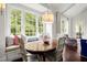 Cozy breakfast nook with banquette seating, light fixture, and view to backyard at 6440 Westchester Pl, Cumming, GA 30040