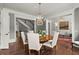 Formal dining room with a chandelier, wood table, and access to other living spaces at 6440 Westchester Pl, Cumming, GA 30040