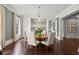 Elegant dining room featuring hardwood floors, stylish chandelier, and ample seating for formal gatherings at 6440 Westchester Pl, Cumming, GA 30040