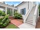 Elegant home exterior featuring brick pathway, stairs, white columns, and blooming hydrangeas adding to curb appeal at 6440 Westchester Pl, Cumming, GA 30040