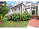 Beautiful home exterior with lush landscaping, brick walkway, manicured lawn and detailed architectural features at 6440 Westchester Pl, Cumming, GA 30040