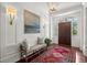 Inviting foyer with elegant lighting, bench seating, and beautiful hardwood floors at 6440 Westchester Pl, Cumming, GA 30040